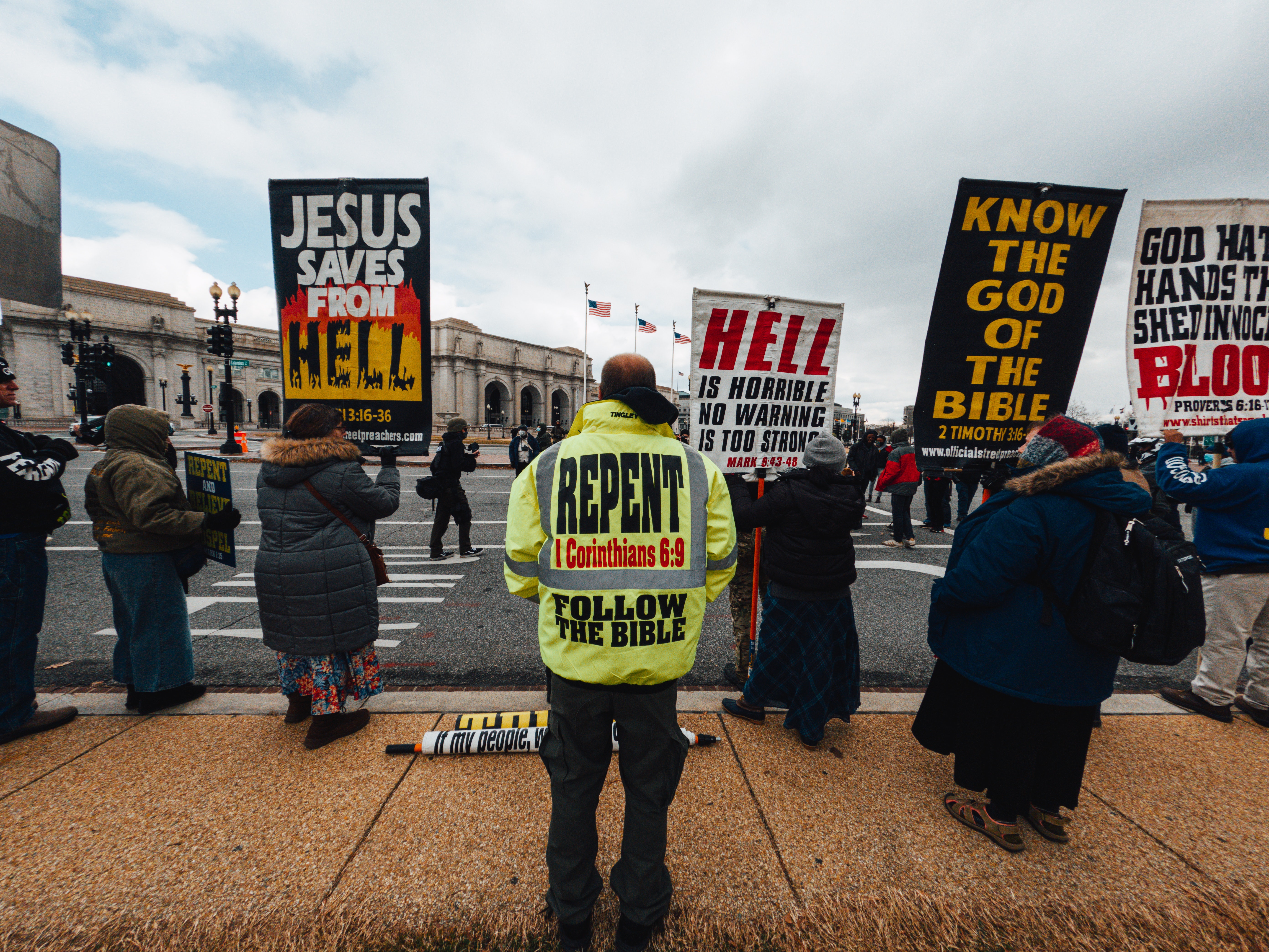 Image of protesters with signs warning about hell.